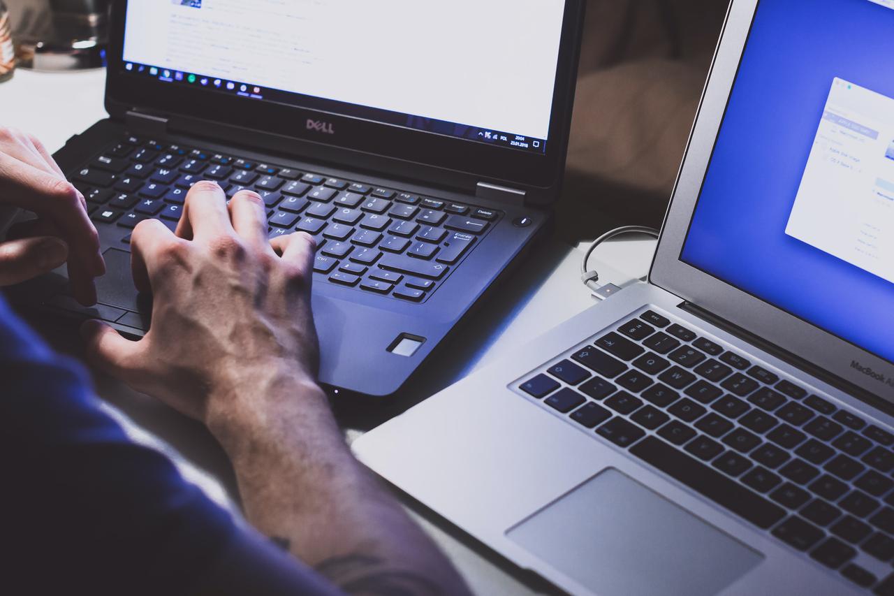 Image of someone typing at a computer, providing outsourced cybersecurity compliance management.