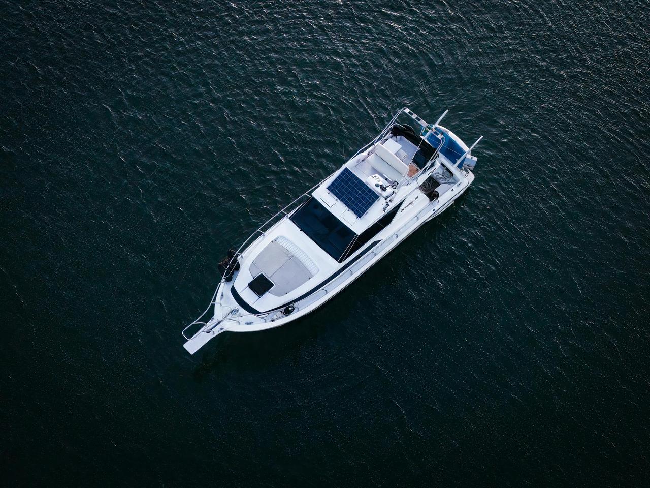 Aerial view of a yacht cruising on the waters of Vitória, Brazil, offering a serene maritime scene.