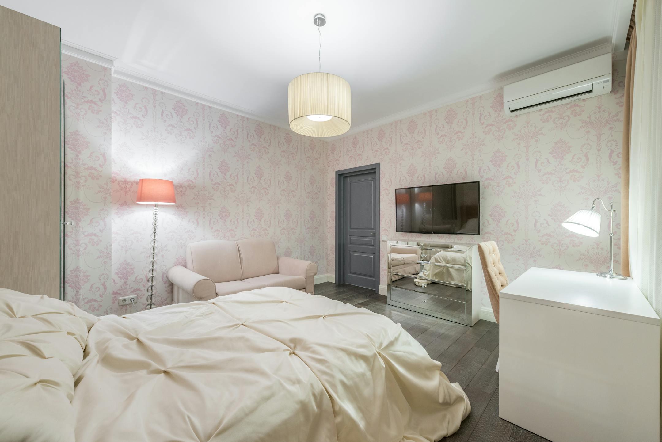 A stylish modern bedroom featuring a comfortable bed and cooling service