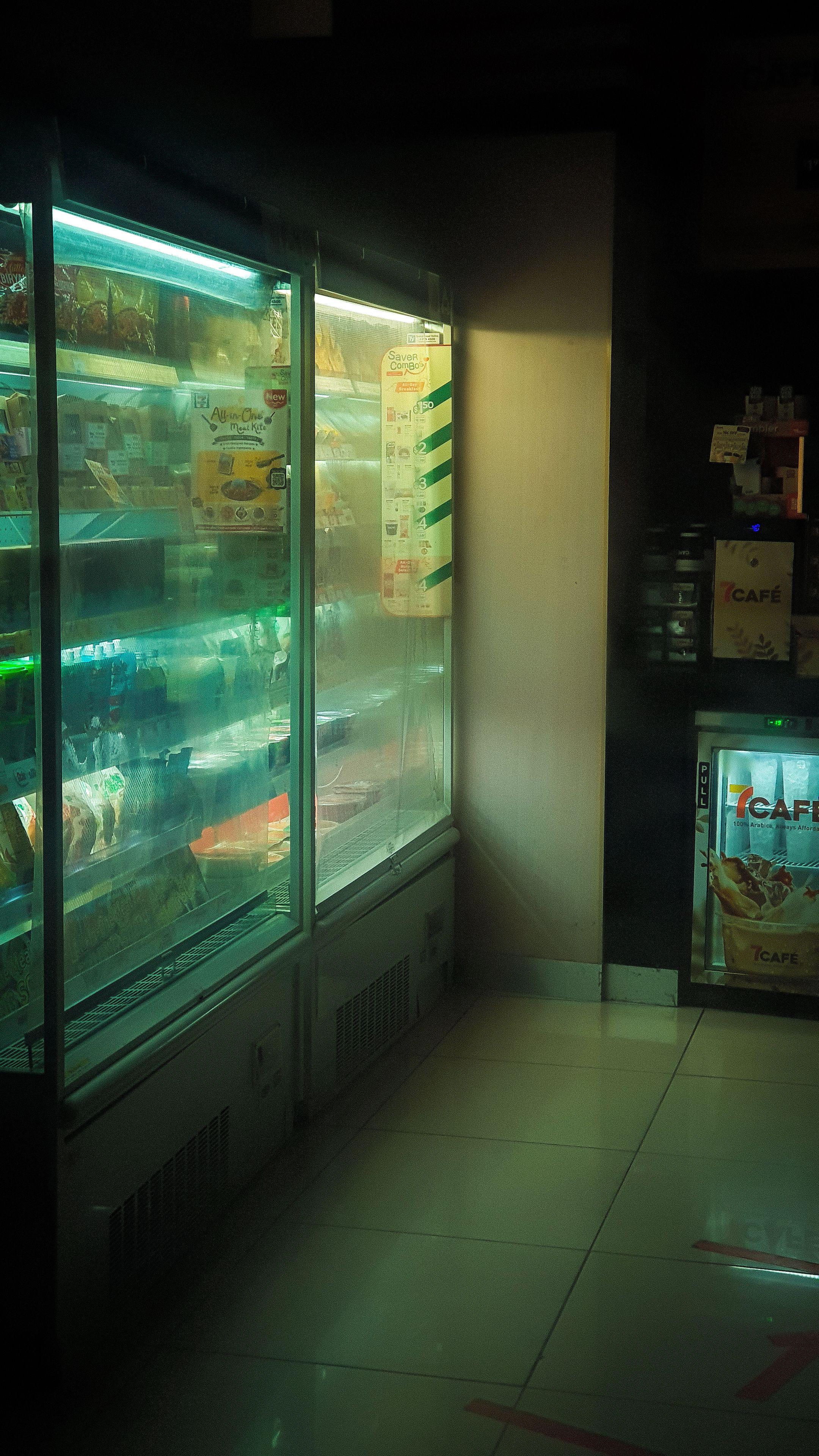 Chilled display in a Singapore store with illuminated beverages and snacks in the cooler.