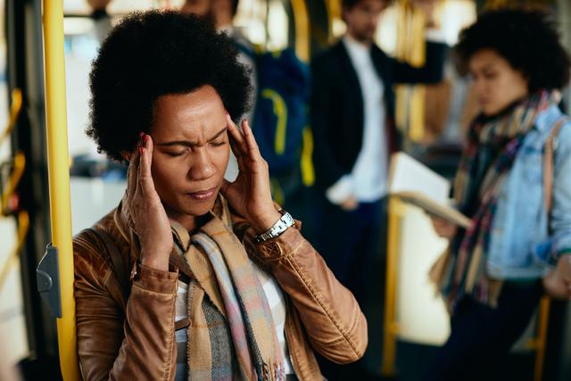 black-woman-holding-her-head-in-pain-wile-travelin-2023-01-31-20-18-35-utc.jpg