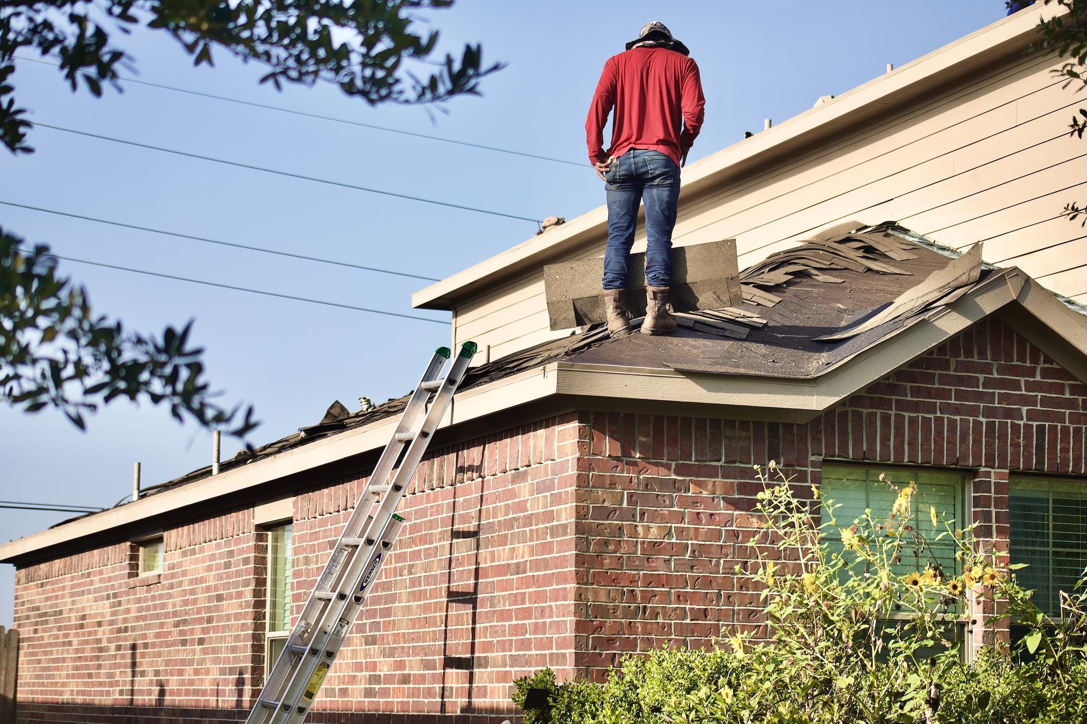 From the work site of a roofing project. The worker tears down the roof before installing an underpayment.