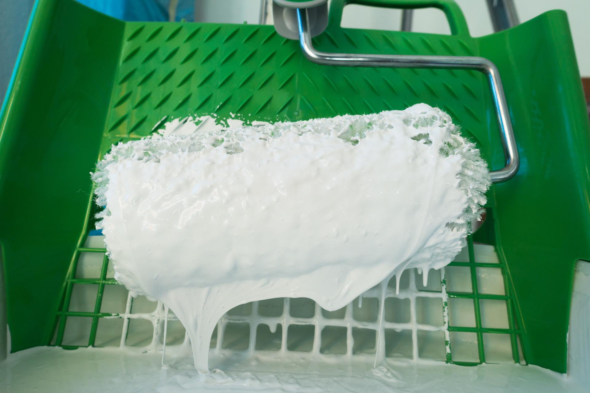 Paint roller covered in white paint