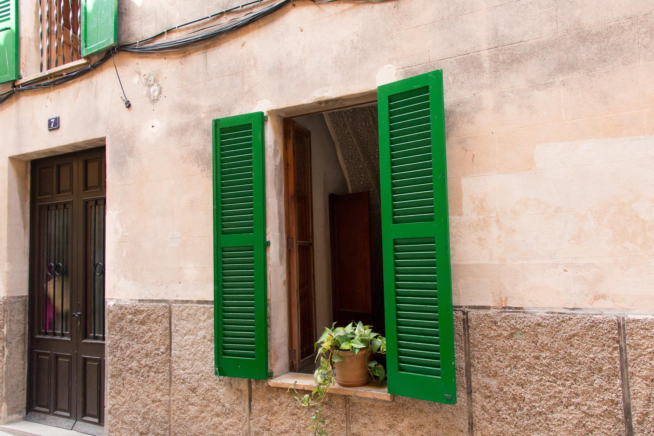 Green shutters on building