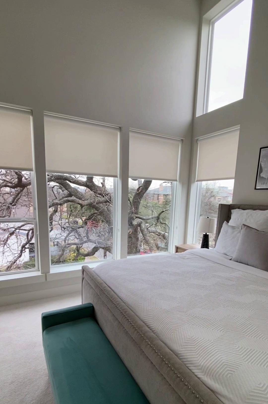 Rolling blinds in white room.