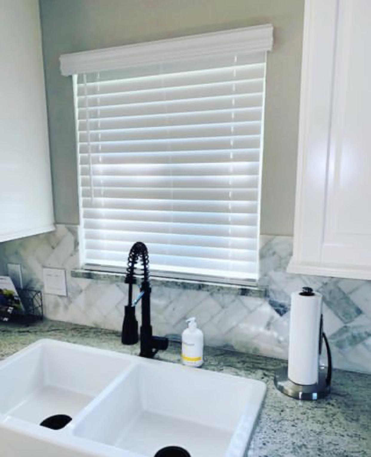 Window treatments over a sink.