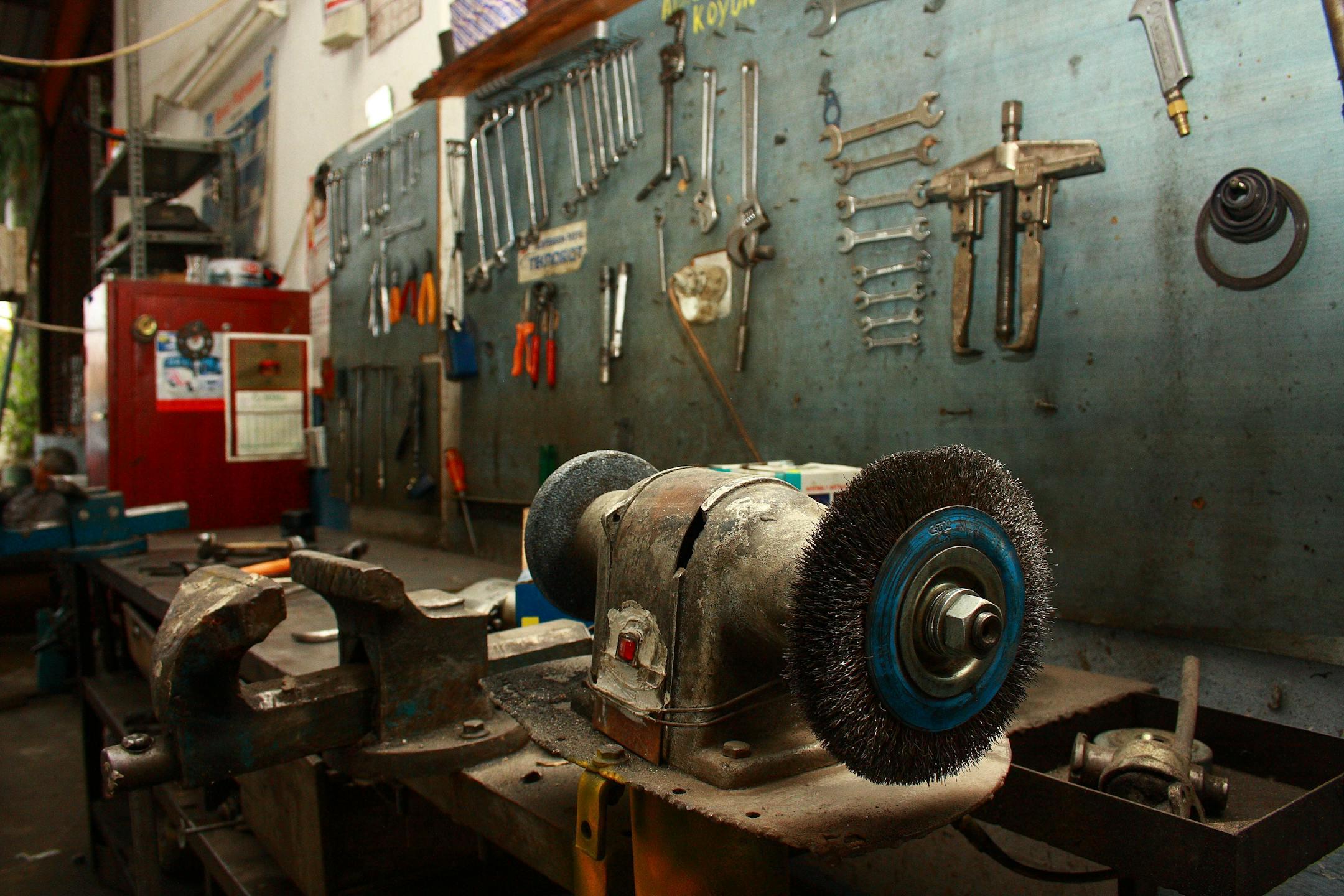 A detailed view of a workshop filled with various tools and machinery, capturing an industrious environment.
