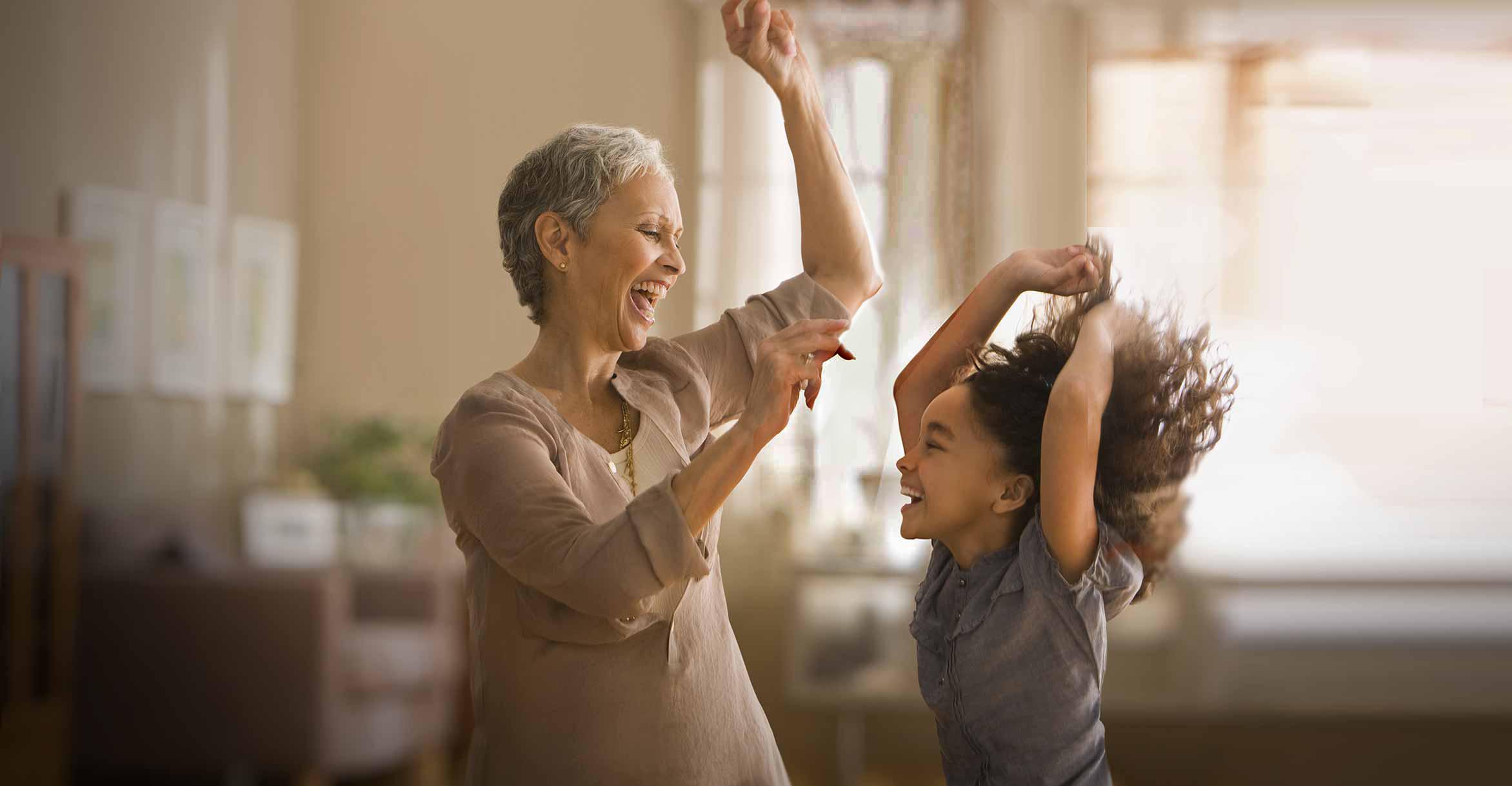 grandmother and child dancing in living room