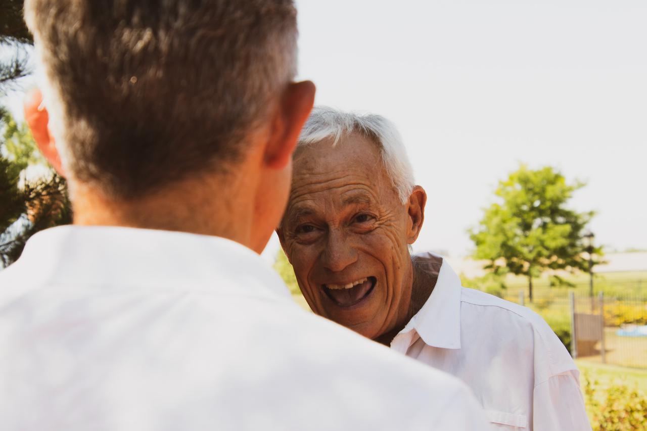 two men in white polo shirts