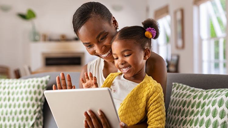 Parent and child using tablet together