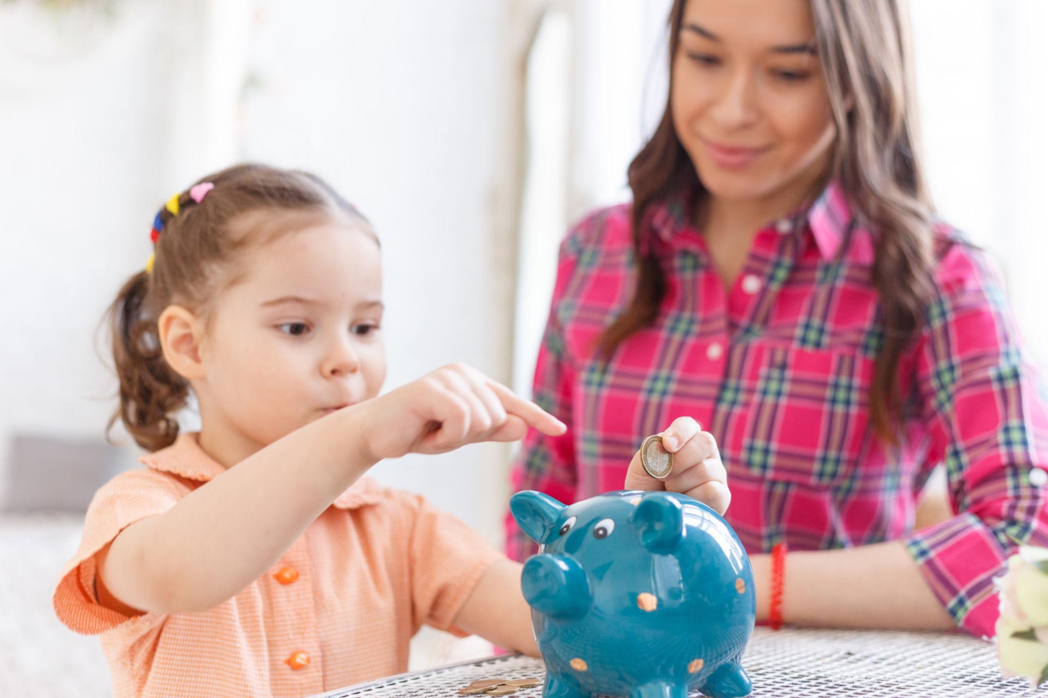 Little girl with piggy bank