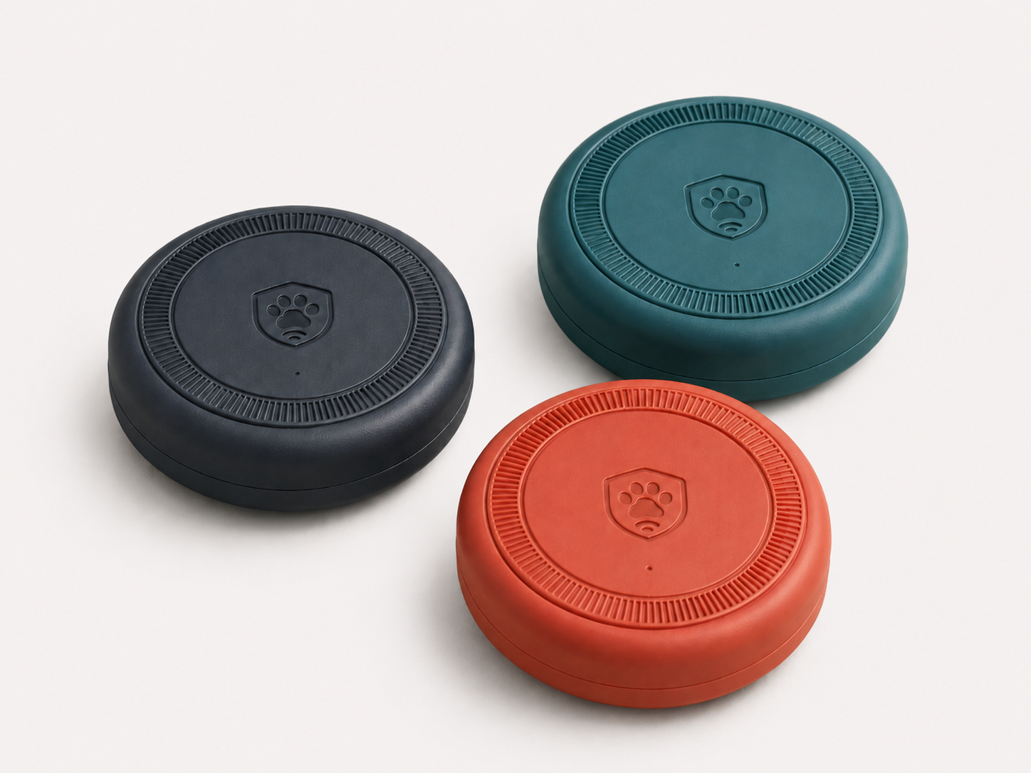 Barrier Buddy Pucks - three white, teal and orange wireless boundary devices