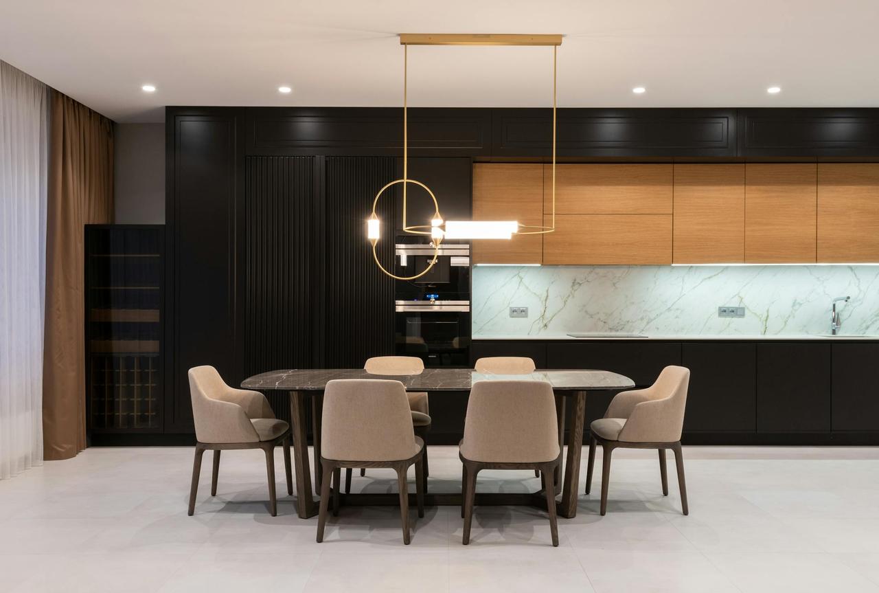 Sleek, minimalist kitchen interior featuring contemporary furnishings and modern lighting.