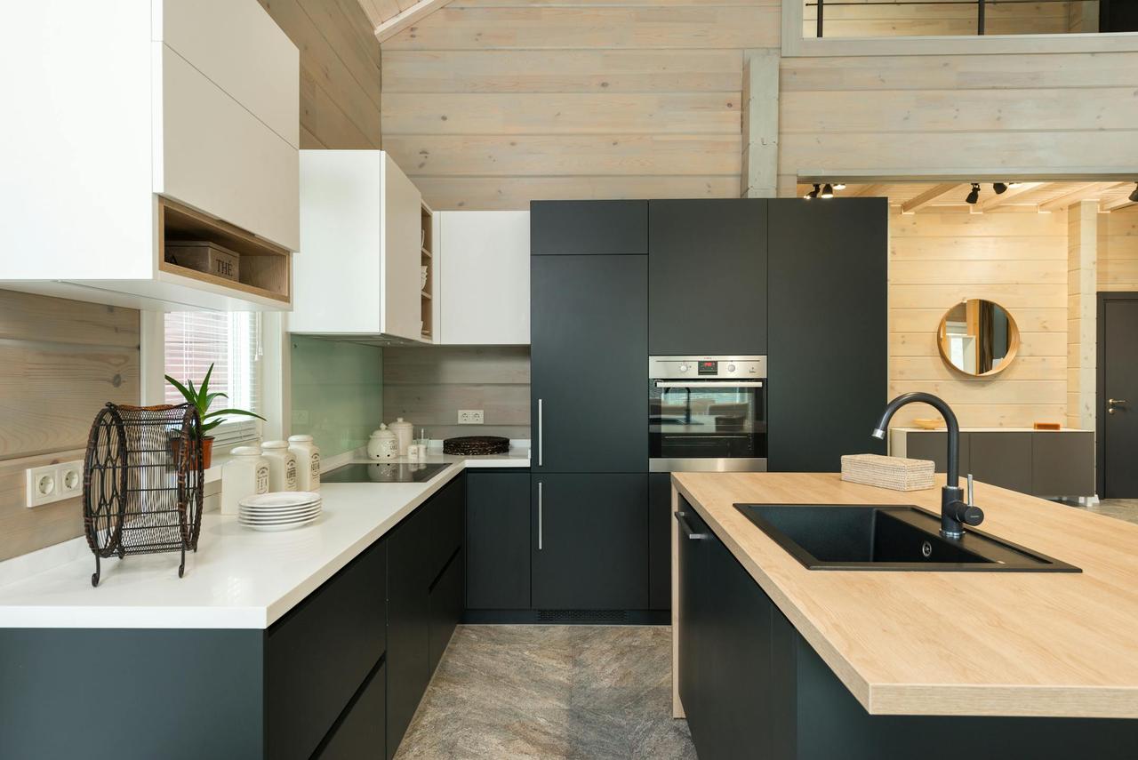 Sleek black and white kitchen with wooden accents and contemporary design.