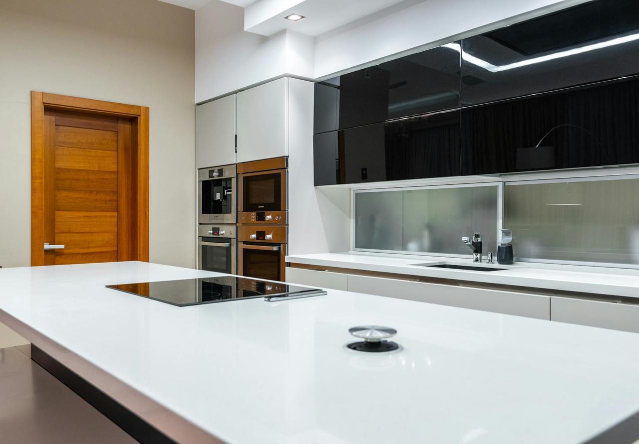 Interior of modern spacious kitchen area with minimalistic style placed in contemporary apartment