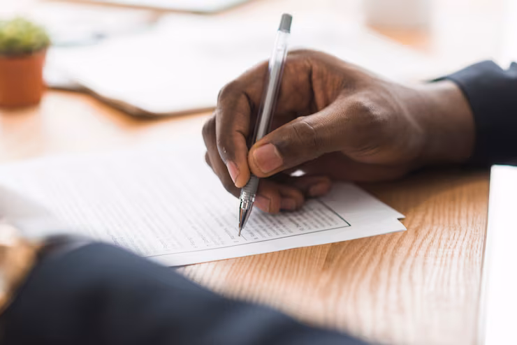 crop-businessman-signing-papers_23-2147768592.jpg