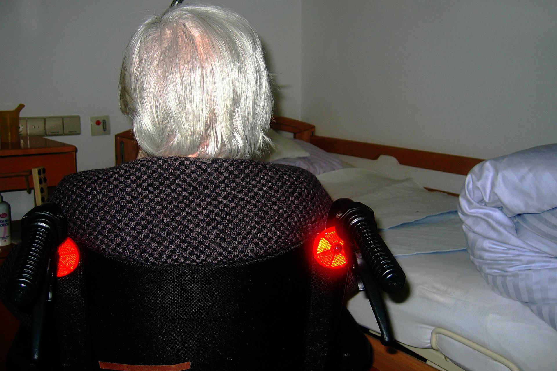 Elderly woman with white hair sitting in a wheelchair