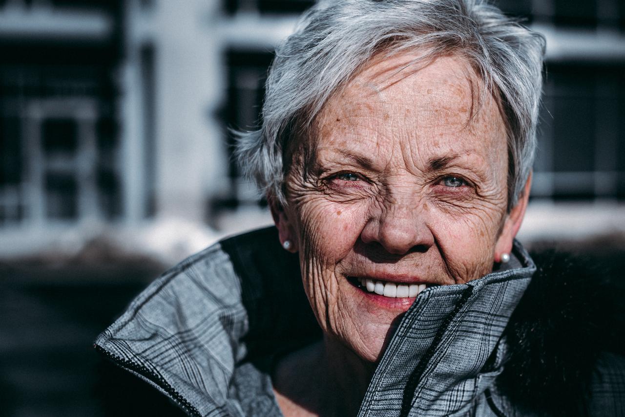 An old woman smiling.
