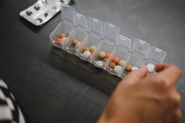 A caretaker managing medication, just one of many home care services in Kettering we offer.