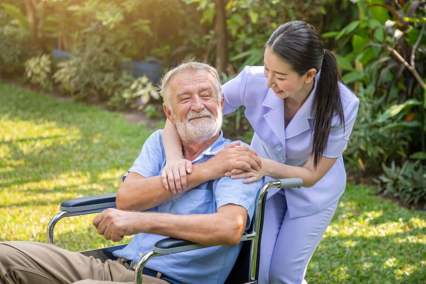 happy-nurse-holding-elderly-man-hand-wheelchair-garden-nursing-home_554837-197.jpg