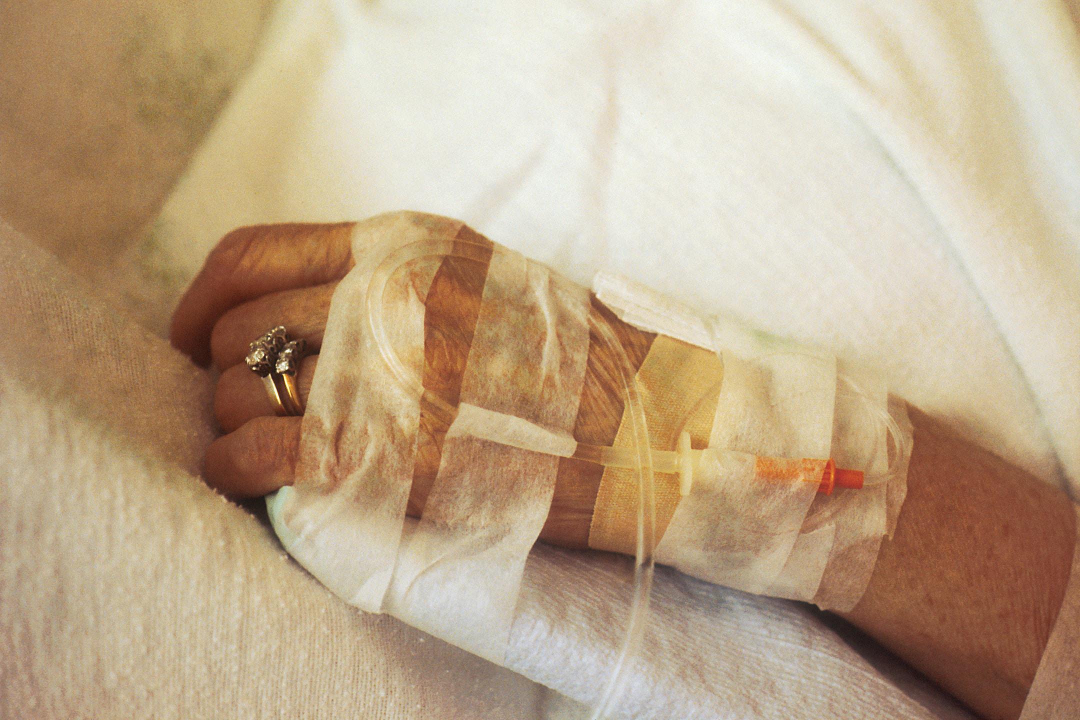 closeup of the hand of an elderly woman recovering at home with after surgery home care