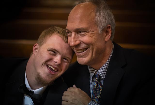 A father with his son smiling.