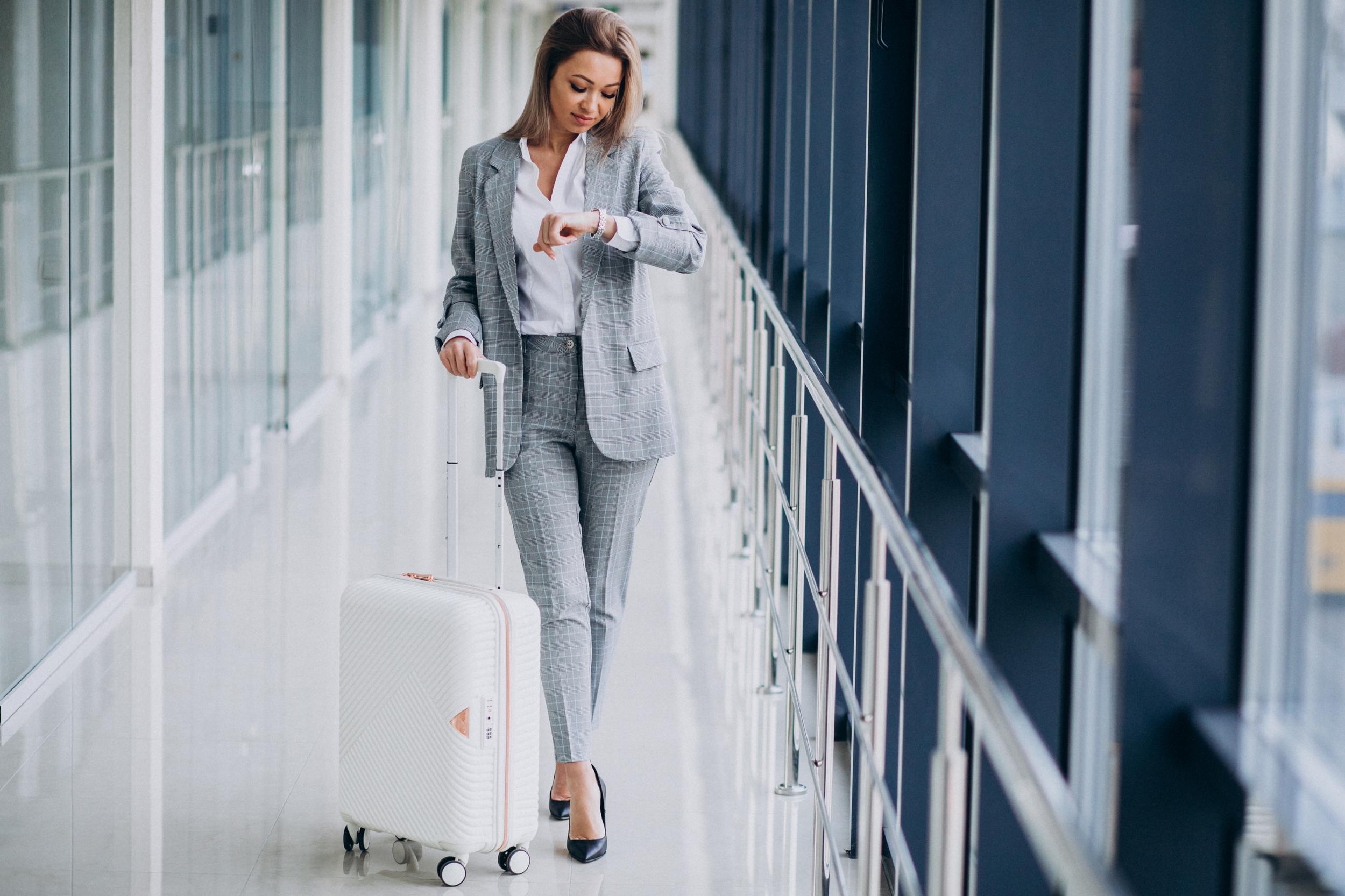 business-woman-with-travel-bag-airport-waiting-flight.jpg