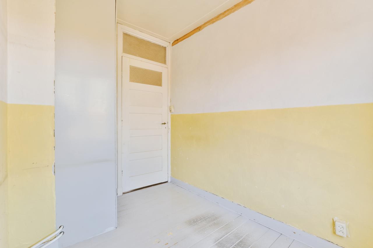 a-room-with-yellow-and-white-walls-and-a-door-2025-02-10-08-18-53-utc.jpg