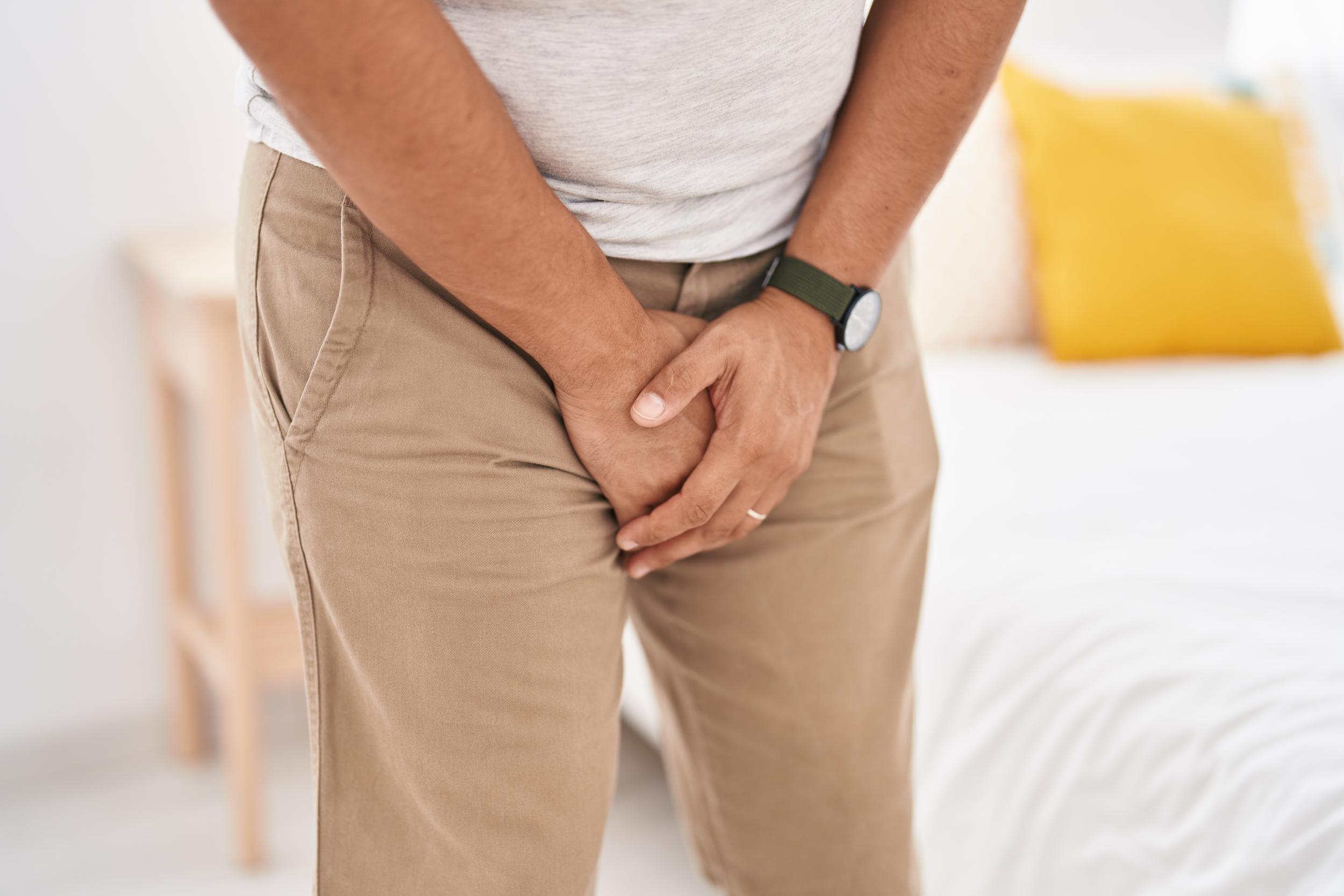 young-latin-man-covering-his-genitals-with-hands-bedroom.jpg