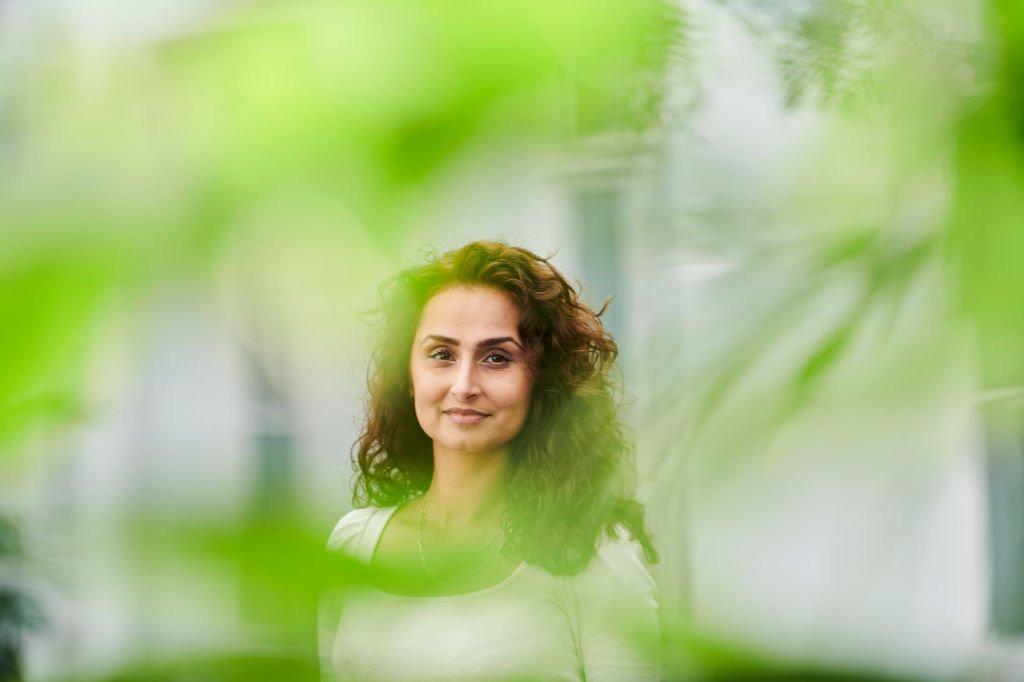 Woman standing behind tree