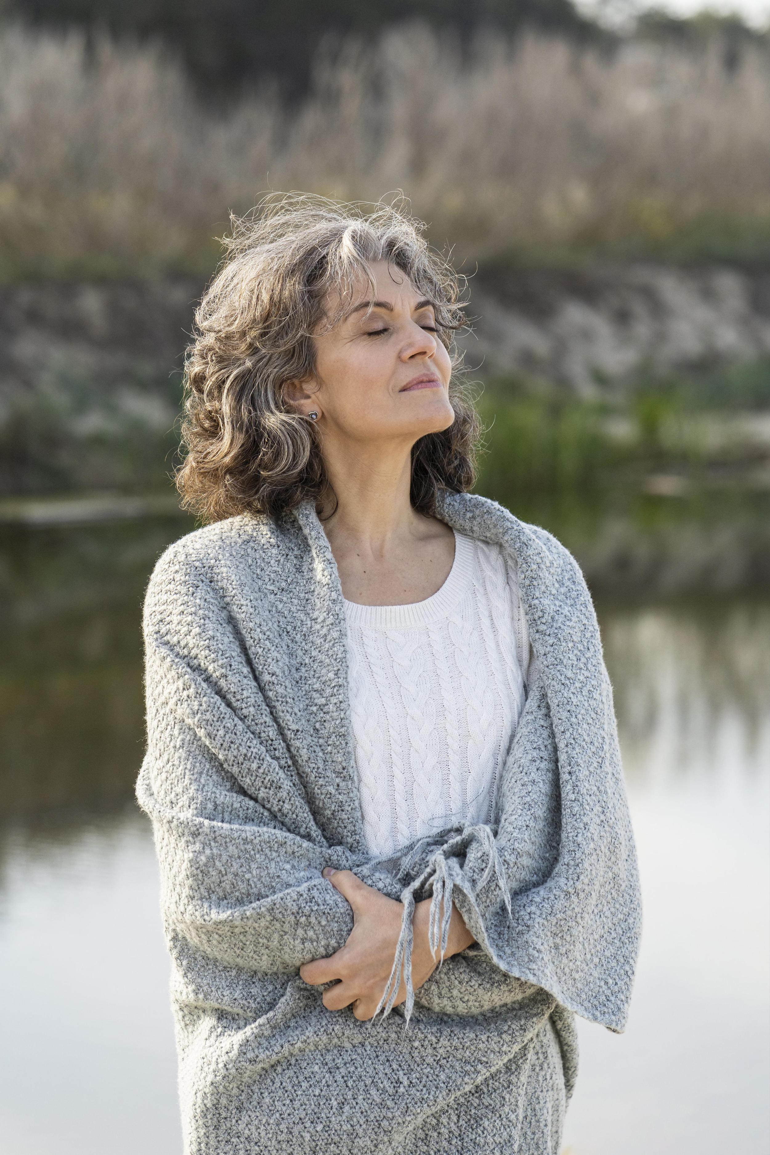 Woman standing by a lake