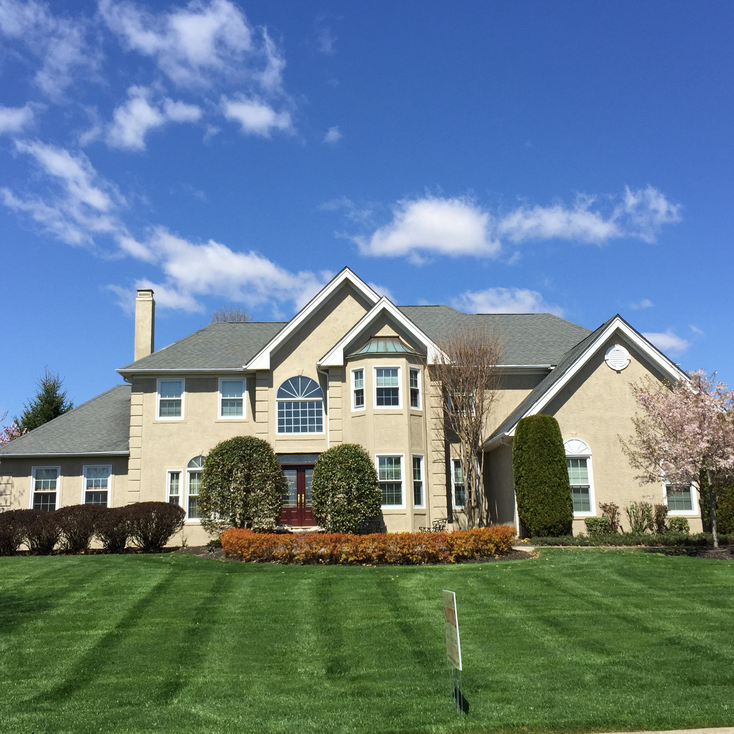 Exterior of large home with freshly cut lawn