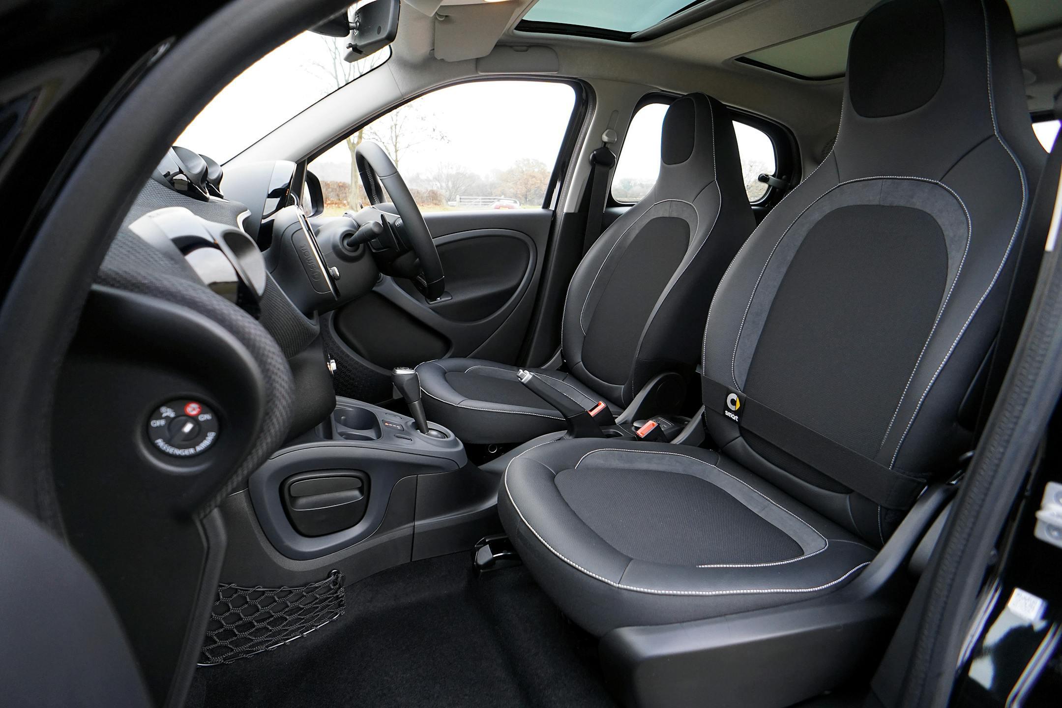 Explore the sleek interior of a modern luxury car featuring leather seats and advanced technology.