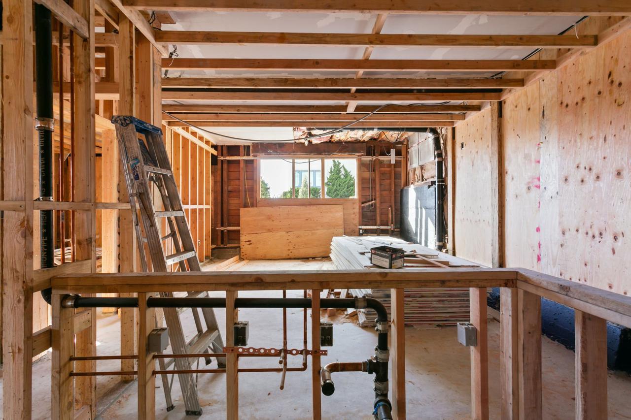 Building under construction with ladder