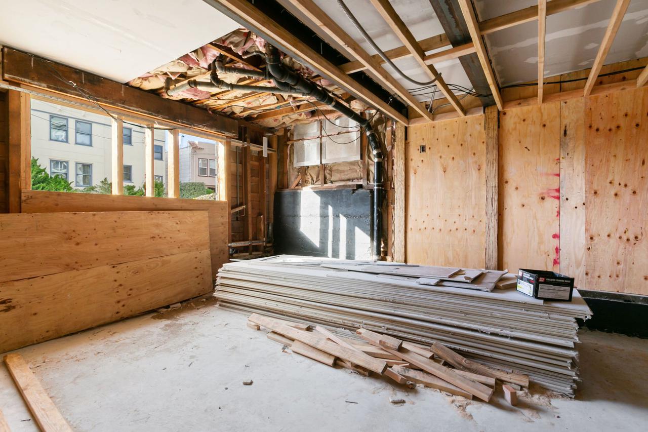 Building under construction with pile of siding