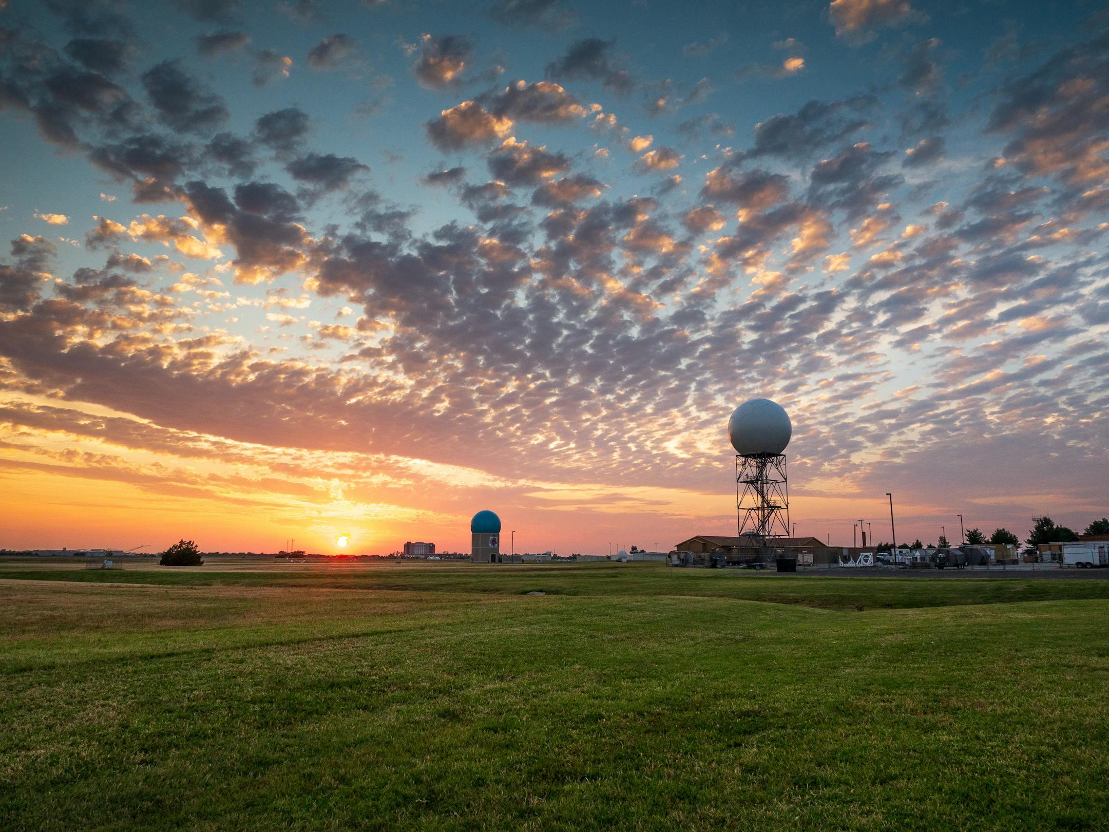 Sunset over a weather station in Norman, Oklahoma, with dramatic sky and clouds.