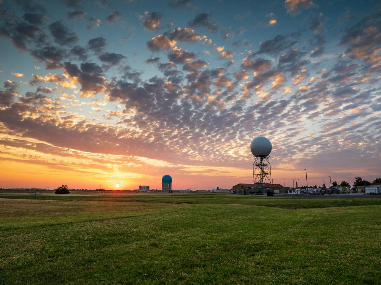 Sunset over a weather station in Norman, Oklahoma, with dramatic sky and clouds.