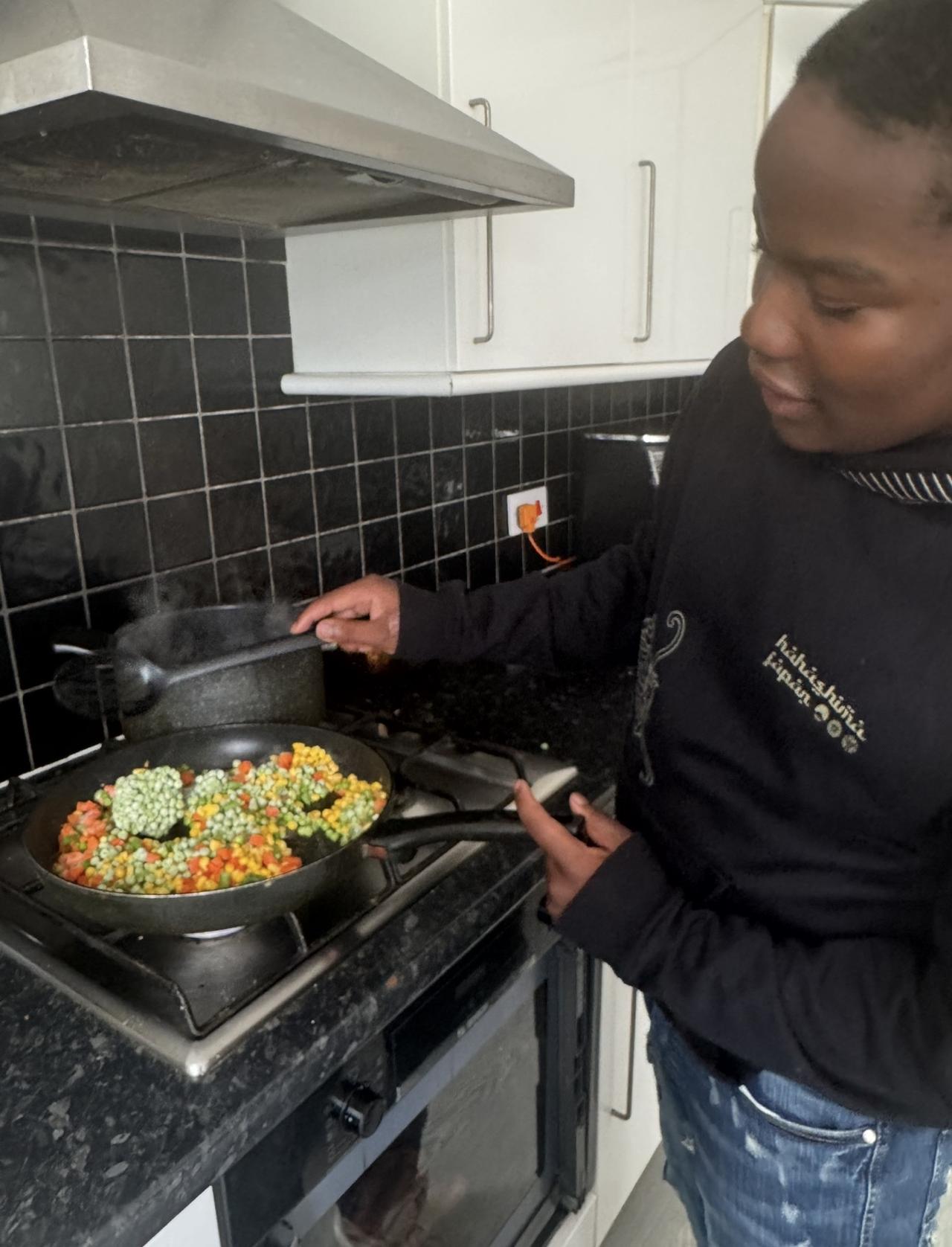 Young person learning to wash dishes and practice practical life skills