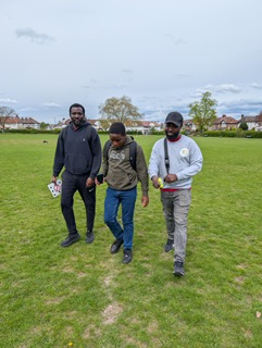 Support worker with young people in a community outdoor setting