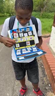 Person using communication device or AAC board with support worker