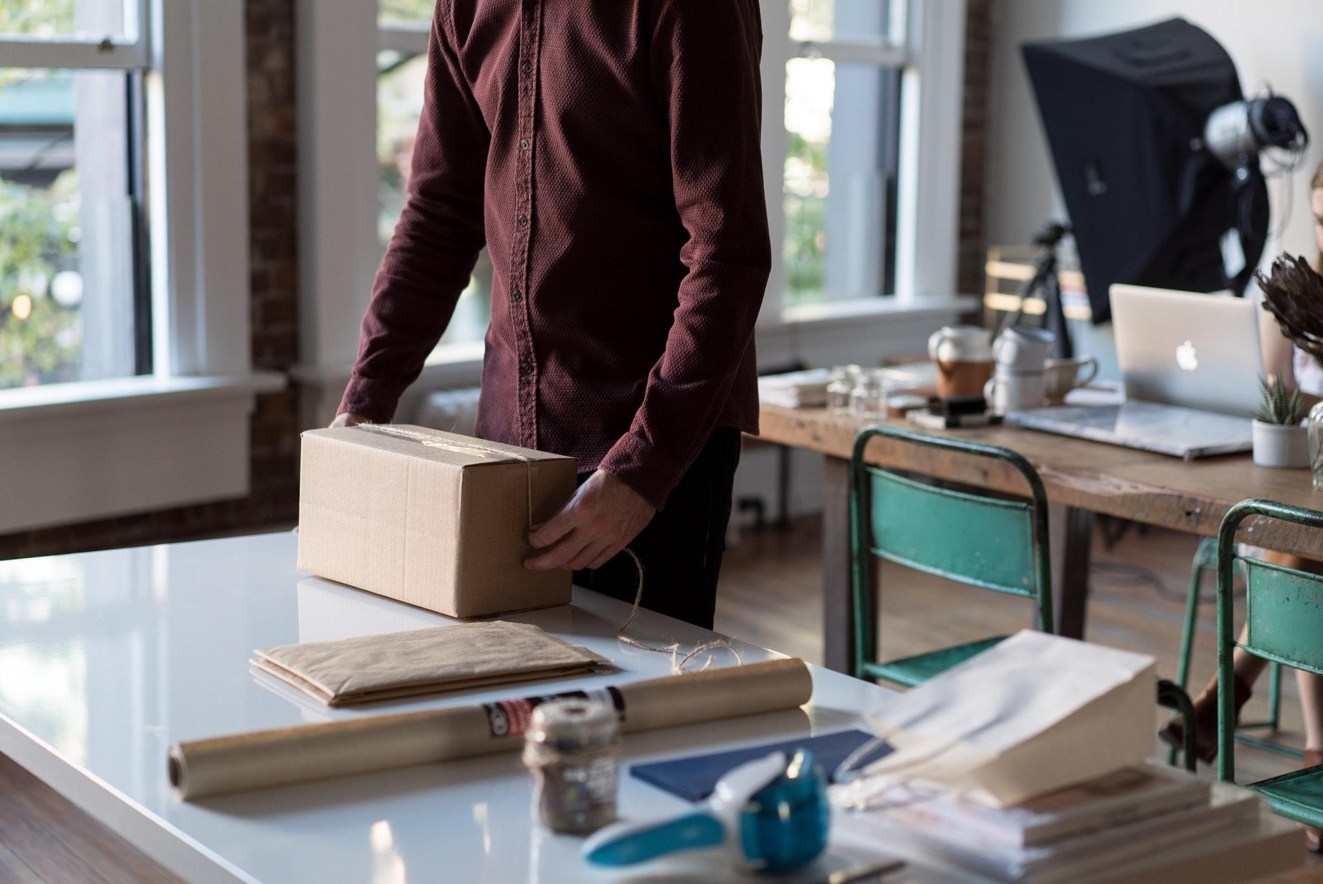 Man sealing a package for shipping