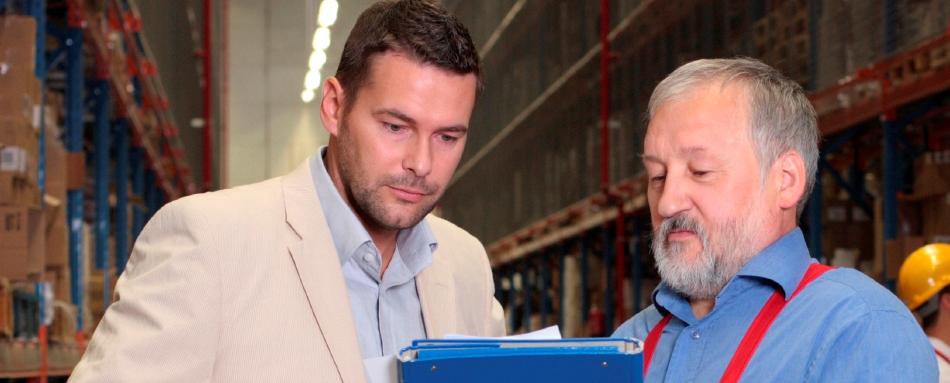 Photo of a hazmat shipping consultant giving advice to a businessman.