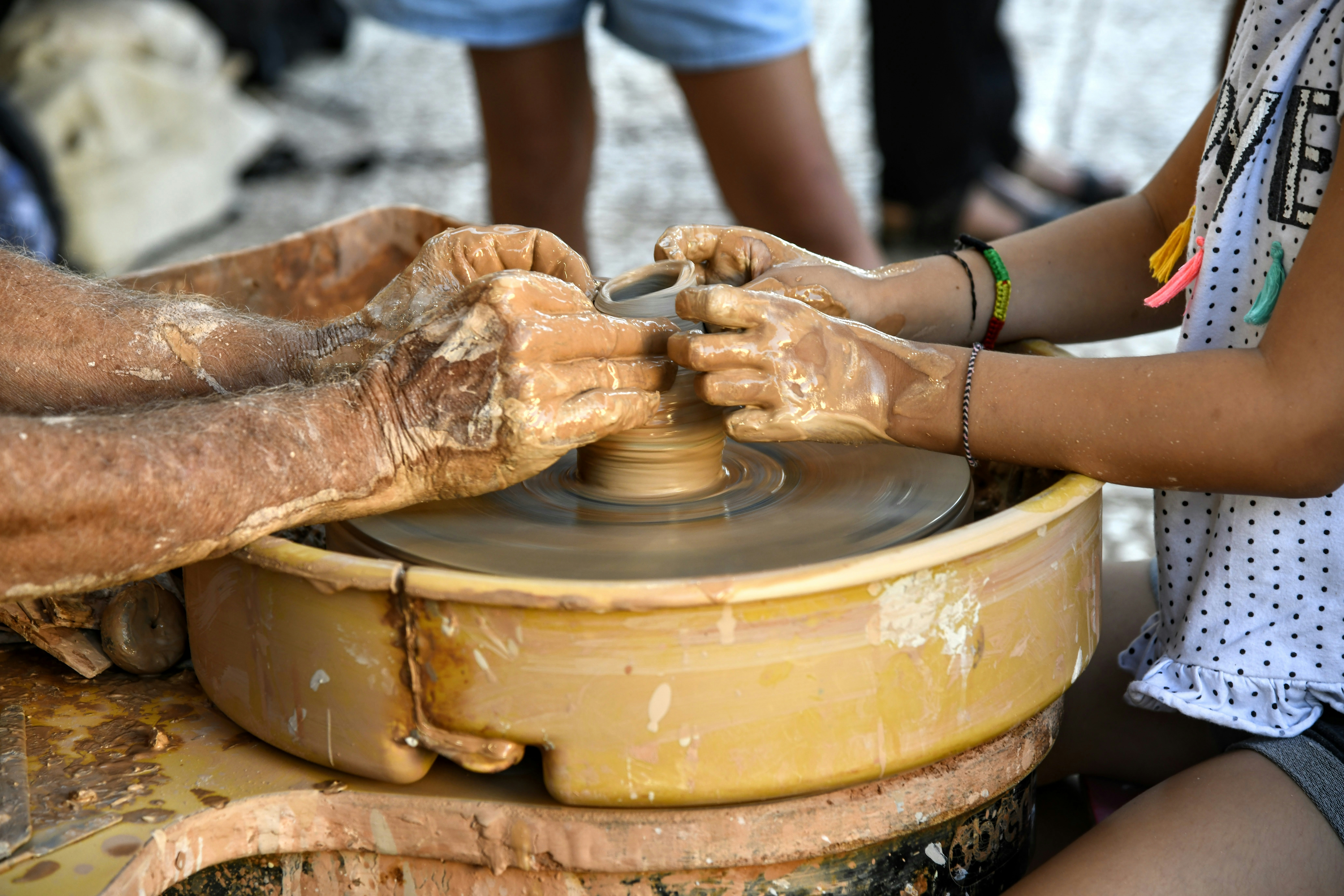 Woman making pottery on a wheel