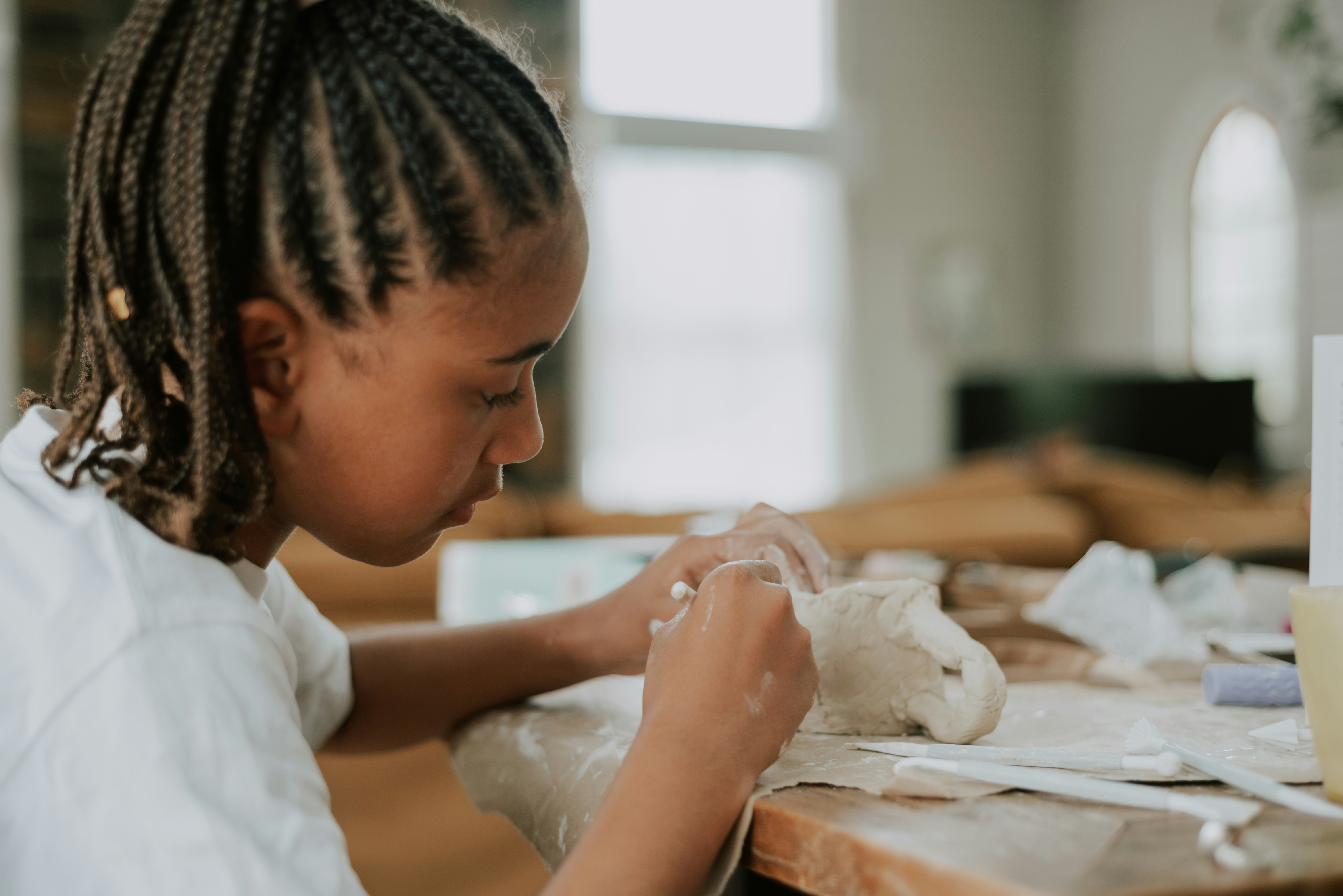 Young girl making a stuffed animal