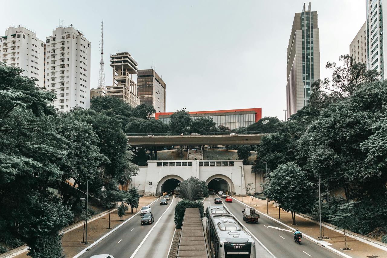 Dynamic São Paulo cityscape featuring iconic skyscrapers and a bustling highway tunnel.