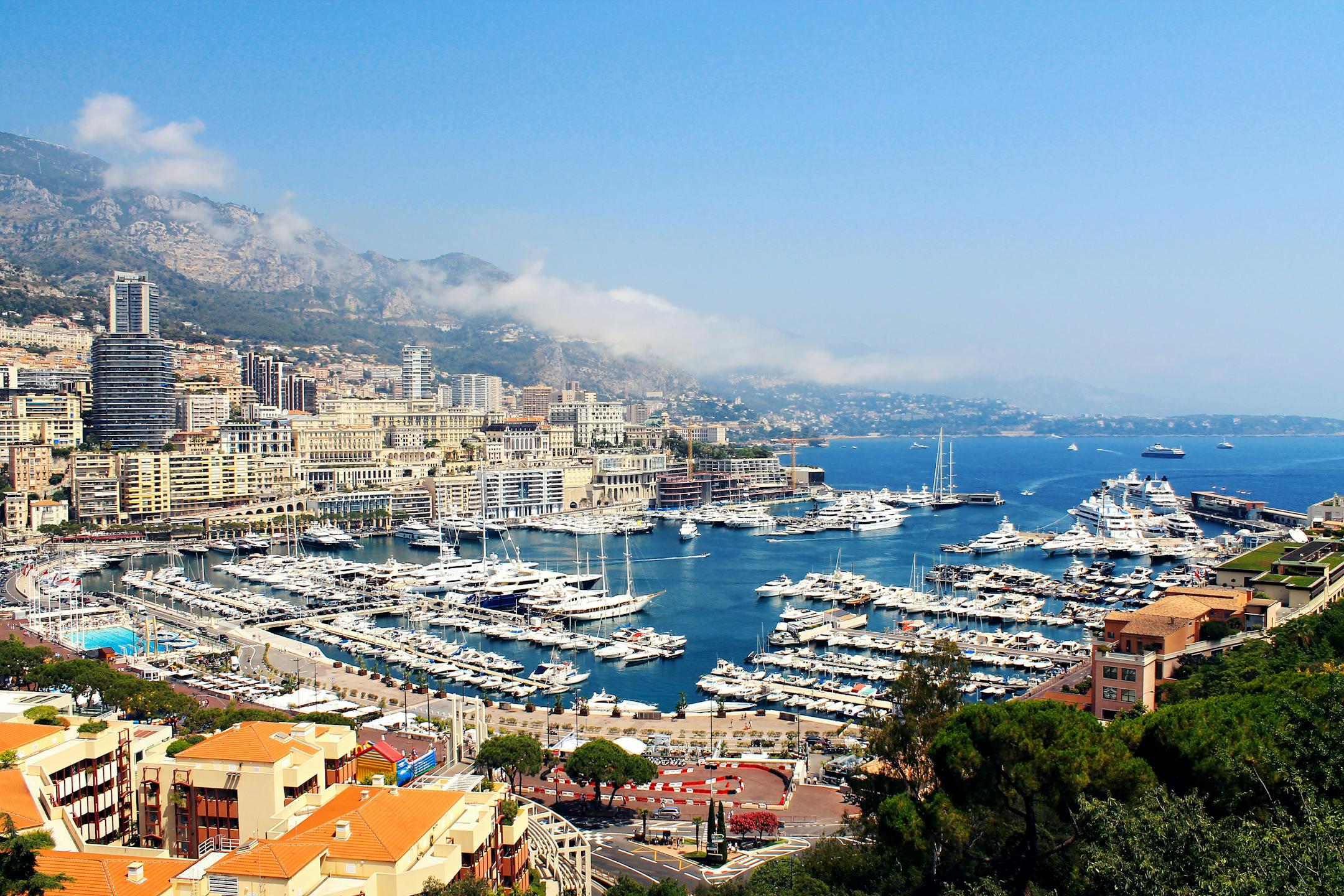 A stunning aerial view of Monte Carlo's marina with yachts and city buildings.