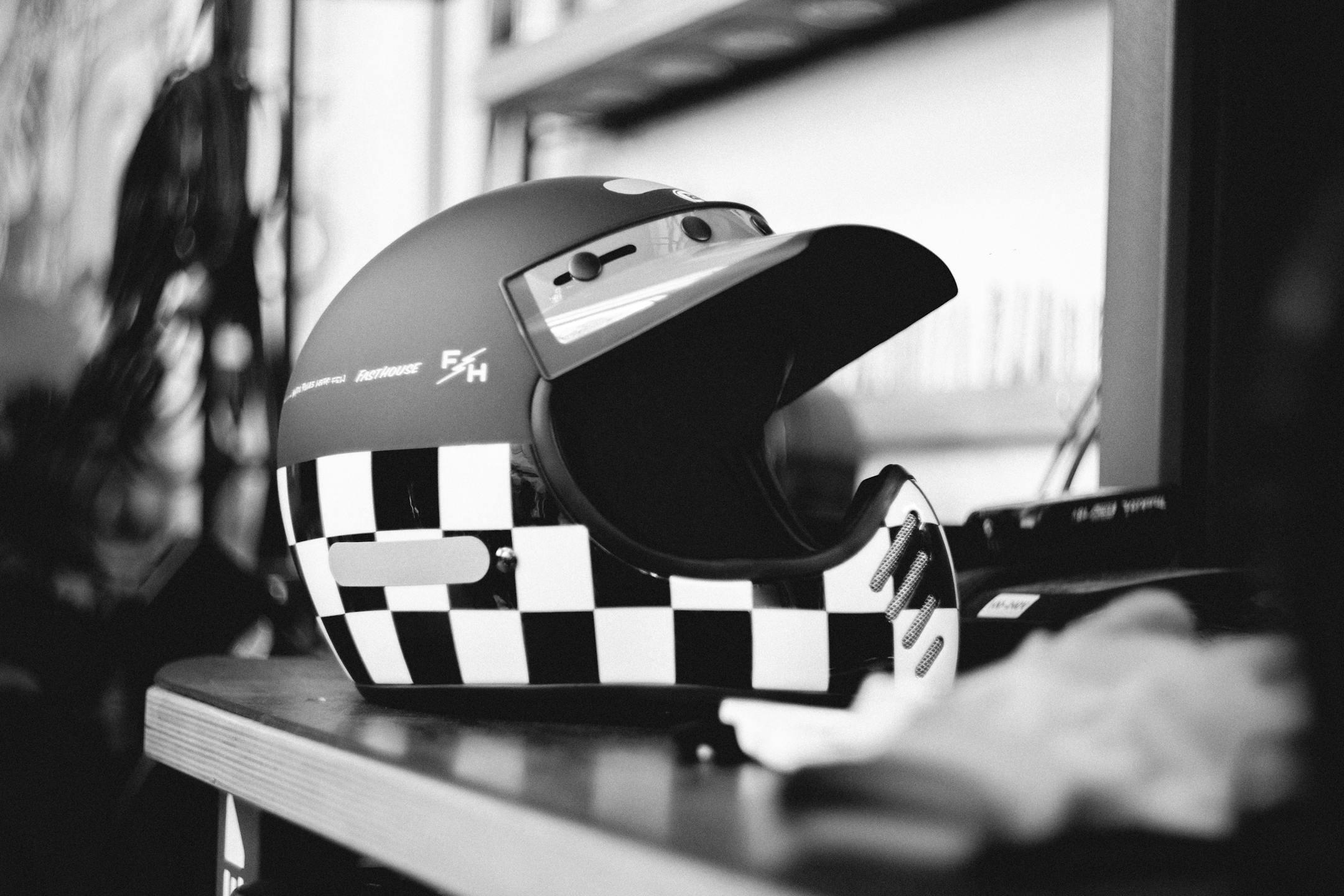 A stylish checkered racing helmet placed indoors, perfect for motor racing enthusiasts.
