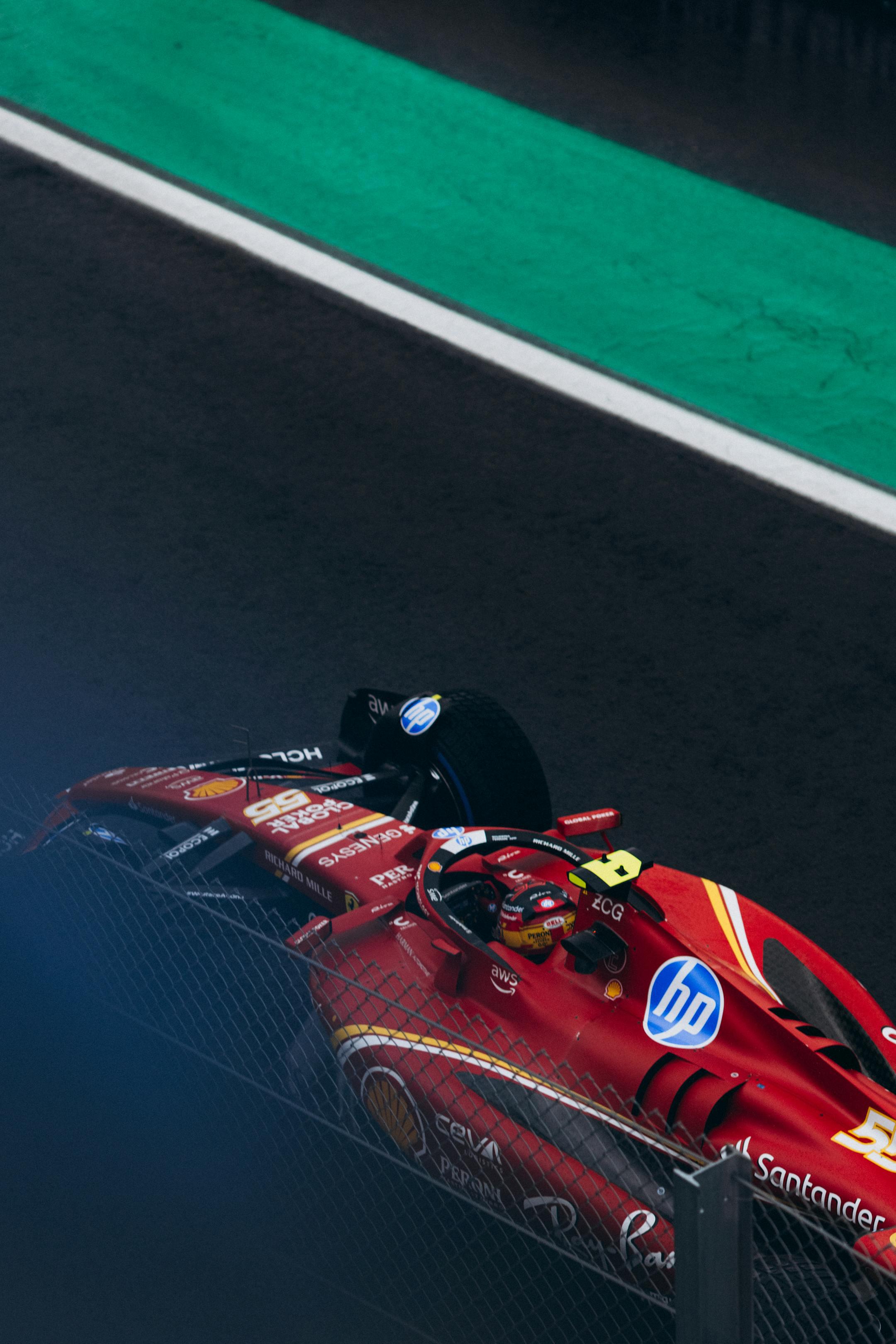 Exciting action shot of a Ferrari F1 car racing at the Interlagos Circuit in Brazil.