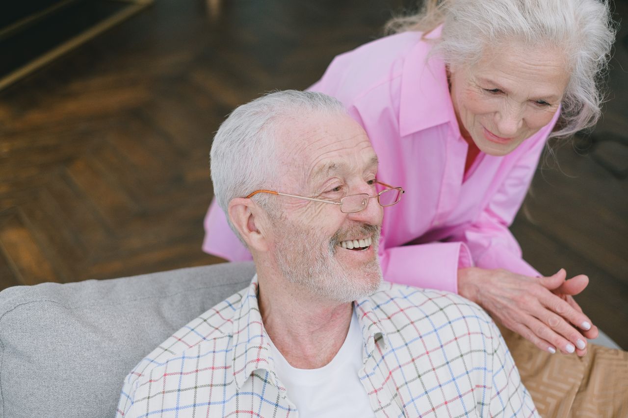 Caregiver supporting elderly man with daily activities