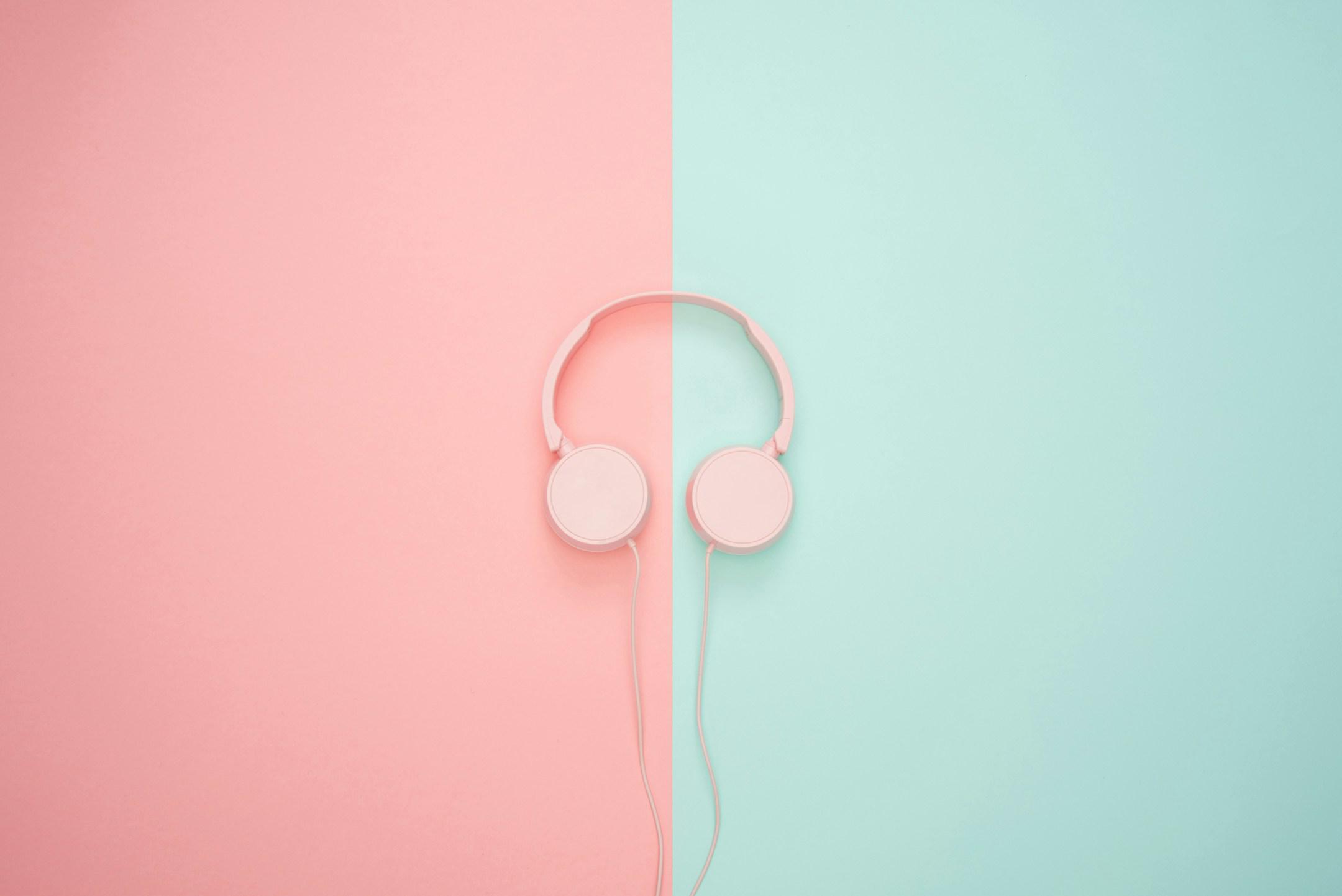 Pink headphones on a pastel background